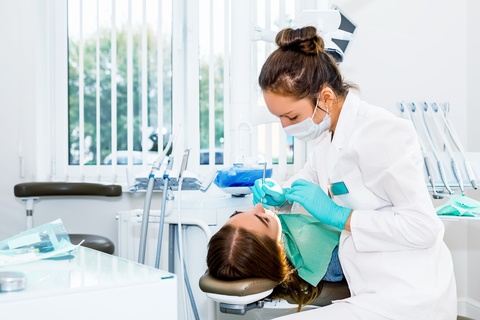 female dentist in rockville md checking patient for gum recession