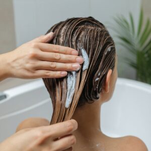 applying coconut oil for hair care before washing